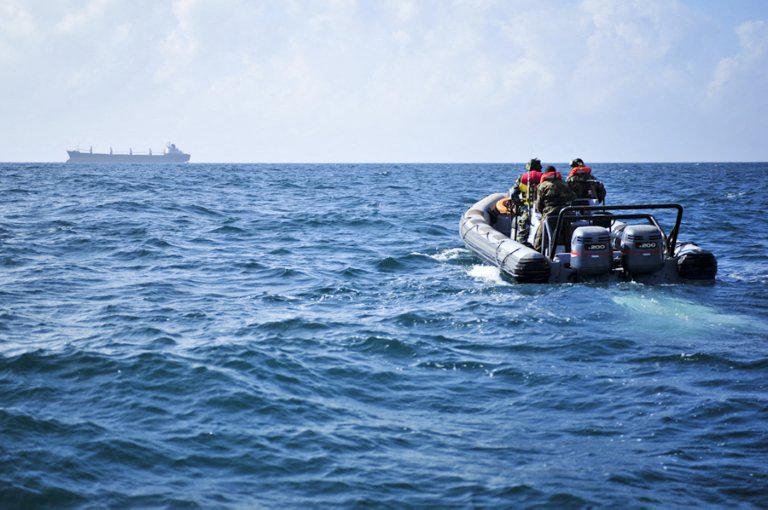 A handout photo released on December 14, 2012 by AU-UN IST shows Ugandan Marines, part of the African Union Mission in Somalia, patrolling the coastline off of the Somali capital of Mogadishu in order to ensure safe passage for flights coming into the city and to protect AMISOM troops on the ground. (AFP)