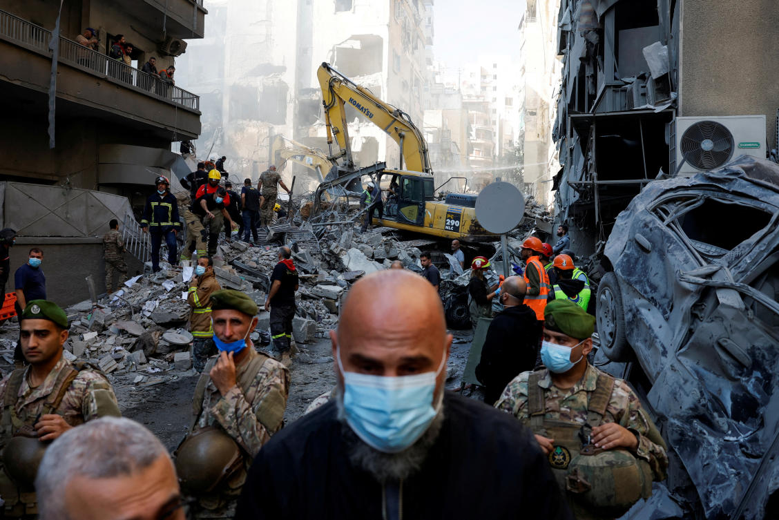 Civil defense members work as Lebanese army soldiers stand guard at the site of an Israeli strike in Beirut’s Basta neighborhood on Nov. 23, 2024. (Reuters)