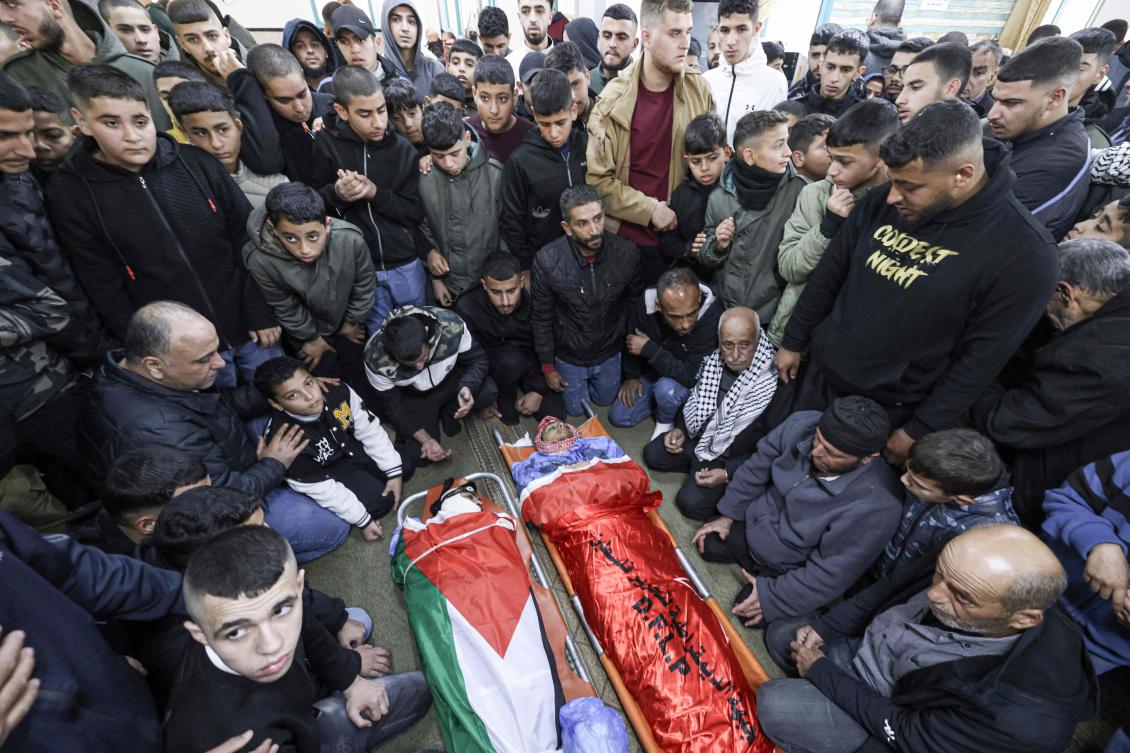 Relatives pray over the bodies of 13-year-old Muhammad Rabie Hamarsheh and 20-year-old Ahmad Mahmud Zaid, who were killed during an Israeli raid, in the town of Yabad west of Jenin in the occupied West Bank on November 25, 2024. (AFP)