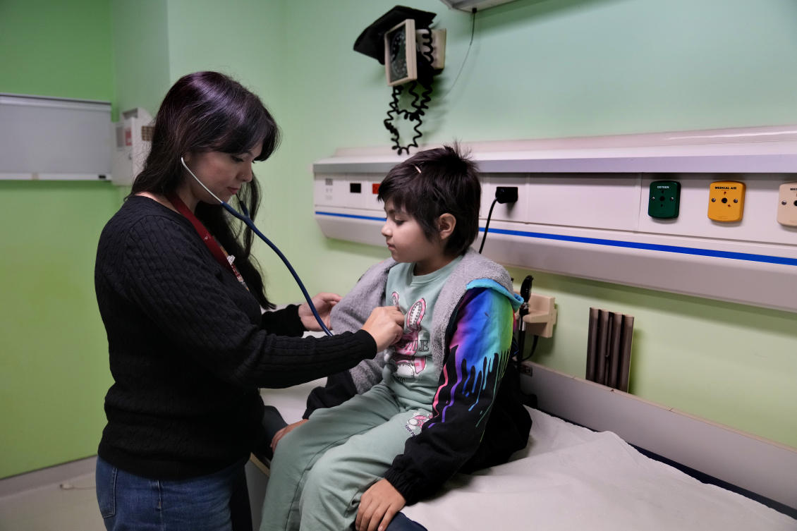 Doctor Dolly Noun, a pediatric hematologist and oncologist, checks Carol Zeghayer, 9, a girl who suffers from leukaemia ahead of her treatment at the Children's Cancer Center of Lebanon, in Beirut. (AP)