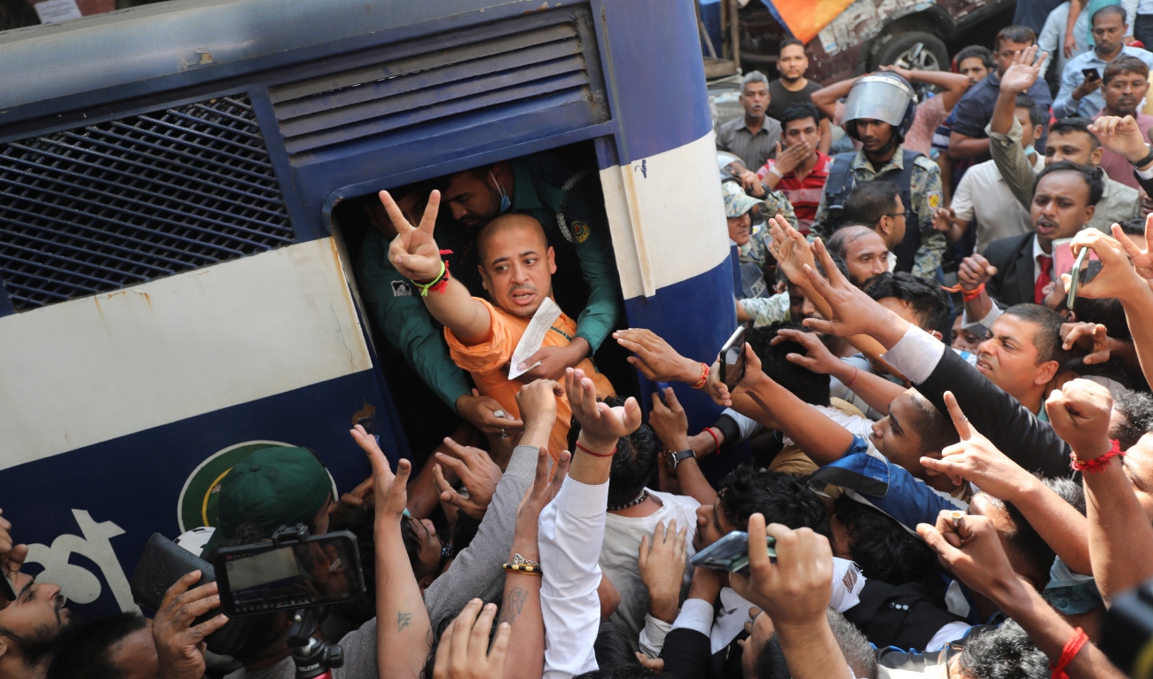 Bangladeshi Hindu leader Krishna Das Prabhu shows a victory sign as he is taken in a police van after court ordered him detained pending further proceedings in Chattogram in southeastern Bangladesh, on November 26, 2024. (AP)