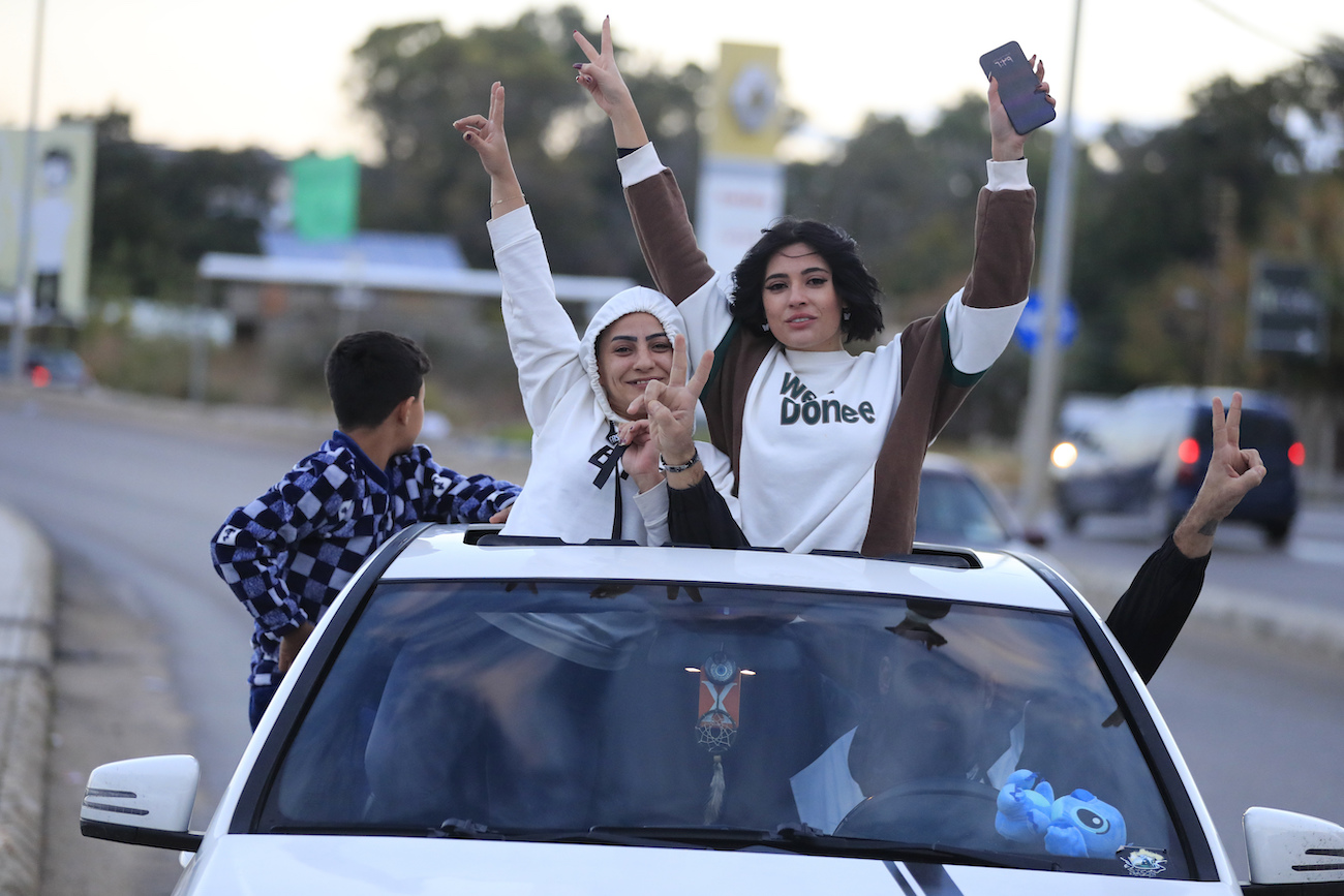 People celebrate after a ceasefire between Israel and Hezbollah went into effect in Sidon, Lebanon, Wednesday, Nov. 27, 2024. (AP)