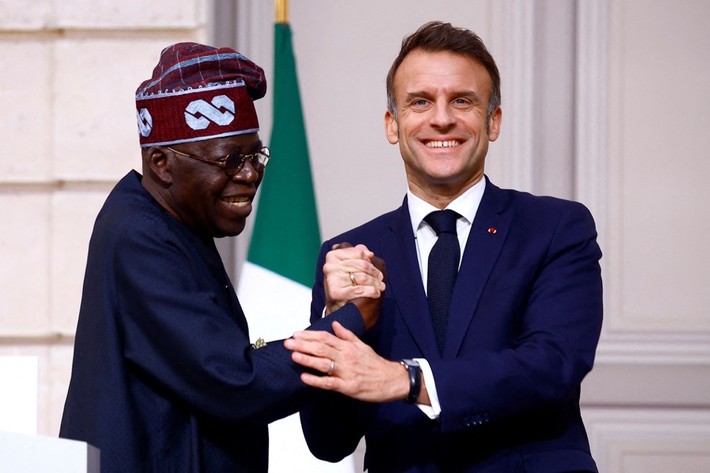 France’s President Emmanuel Macron and his Nigerian counterpart Bola Tinubu. (Reuters)