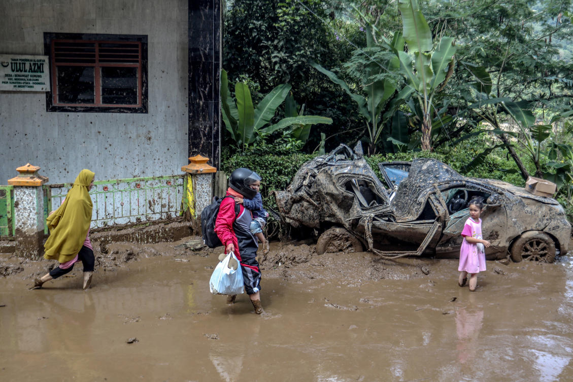 At least five cars, one bus, and one truck were trapped at the base of a cliff following the landslide. (AFP/FILE)