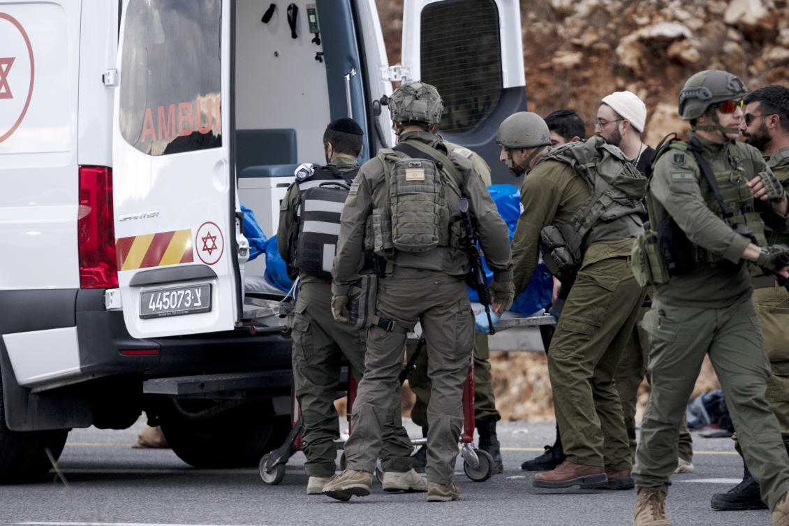 Israeli soldiers load the body of a suspected Palestinian gunman into an ambulance after a shooting attack targeting an Israeli bus that injured at least three people before the gunman was shot and killed, near the West Bank settlement of Ariel, on Nov. 29, 2024. (AP)