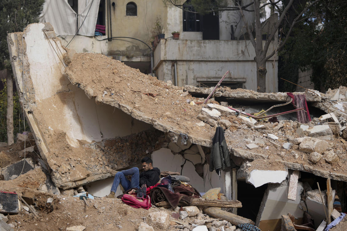 A man sits on the rubble of a destroyed house in Baalbek, eastern Lebanon, on Nov. 28, 2024. (AP)