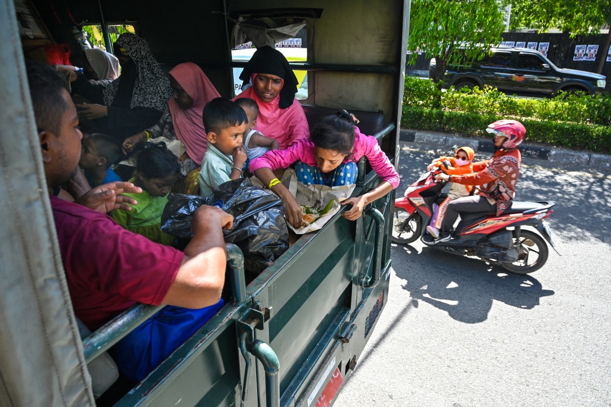 Rohingya refugees sit on a truck after being relocated from Southern Aceh province to Banda Aceh on November 7, 2024 (AFP)