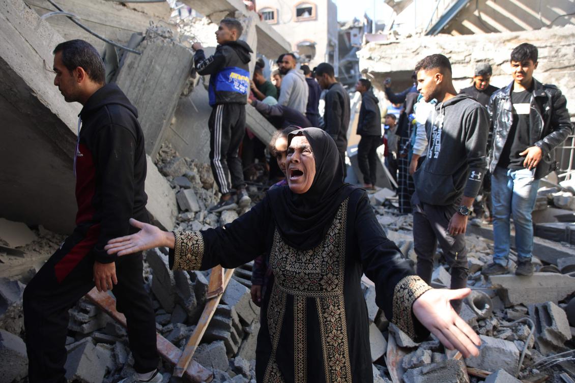 A Palestinian woman reacts as she stands amid the rubble of a building destroyed in an Israeli strike on the Shujaiyah neighborhood in Gaza City on Nov. 30, 2024. (AFP)