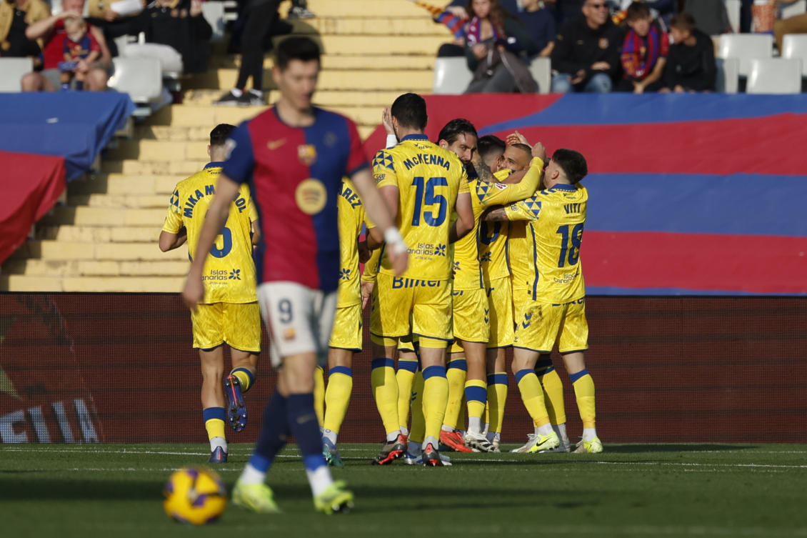 Las Palmas’ players celebrate after their teammate Sandro Ramirez scoring the opening goal against Barcelona during their Spanish La Liga match at the Lluis Companys Olympic Stadium in Barcelona, on Nov. 30, 2024. (AP)