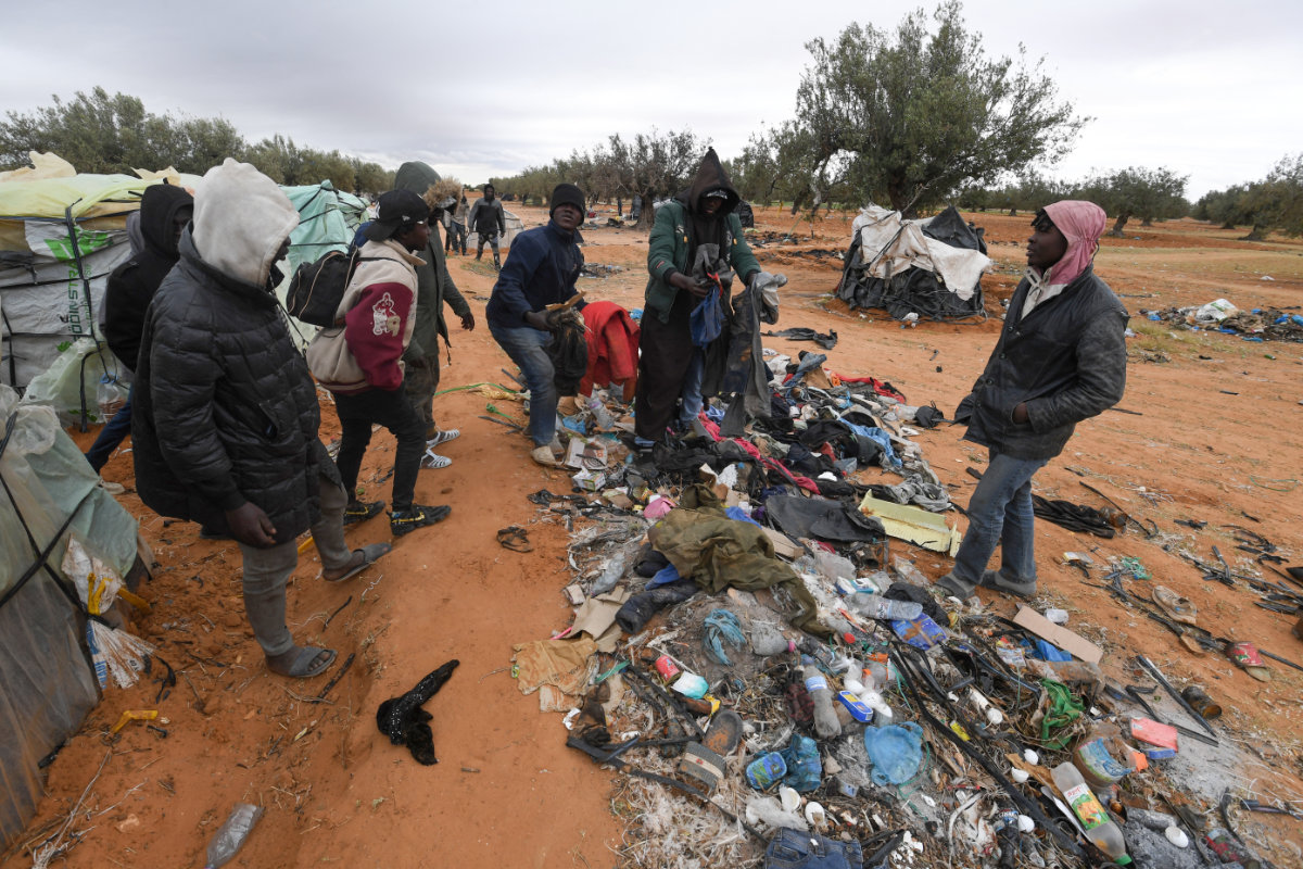 Migrant from Sub-Saharan Africa gather at a camp in Jebeniana in Tunisia's Sfax governorate on April 24, 2024. (AFP)