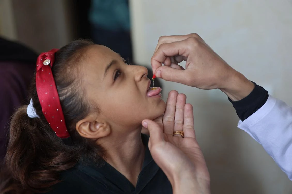 A medic administers a polio vaccine to a Palestinian child at Abdel Aziz Rantissi hospital in Gaza City’s Nasr district which was reopened on Nov. 2, 2024, after sustaining heavy damage in Israeli bombardment of the area amid the ongoing war in the Palestinian territory between Israel and Hamas. (AFP)