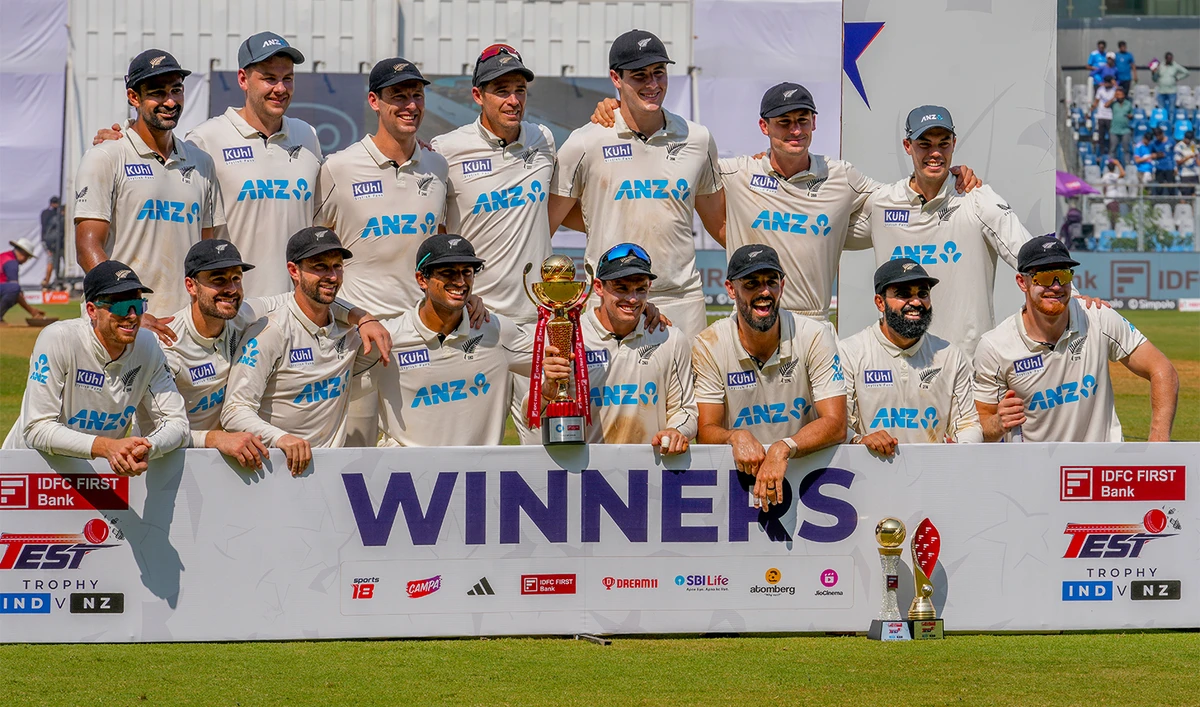 New Zealand's players celebrate with the trophy after winning the three test match series against India at Wankhede Stadium, in Mumbai, India, on November 3, 2024. (AP)