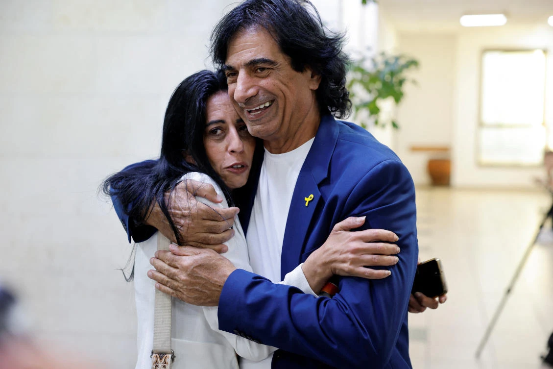 The father of hostage Idan Shtivi and the mother of hostage Matan Zangauker hug in court following a ruling on the lifting of a gag order on an ongoing investigation into the suspected leak of classified documents seized in Gaza by Netanyahu's circle, in Rishon Lezion, Israel, November 3, 2024. (Reuters)