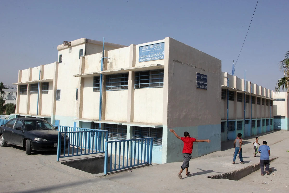 Palestinian refugee pupils play outside a United nations Relief and Works Agency's (UNRWA, UN agency for Palestinian refugees) school, in the Baqa'a Palestinian refugee camp, near Amman (AFP)