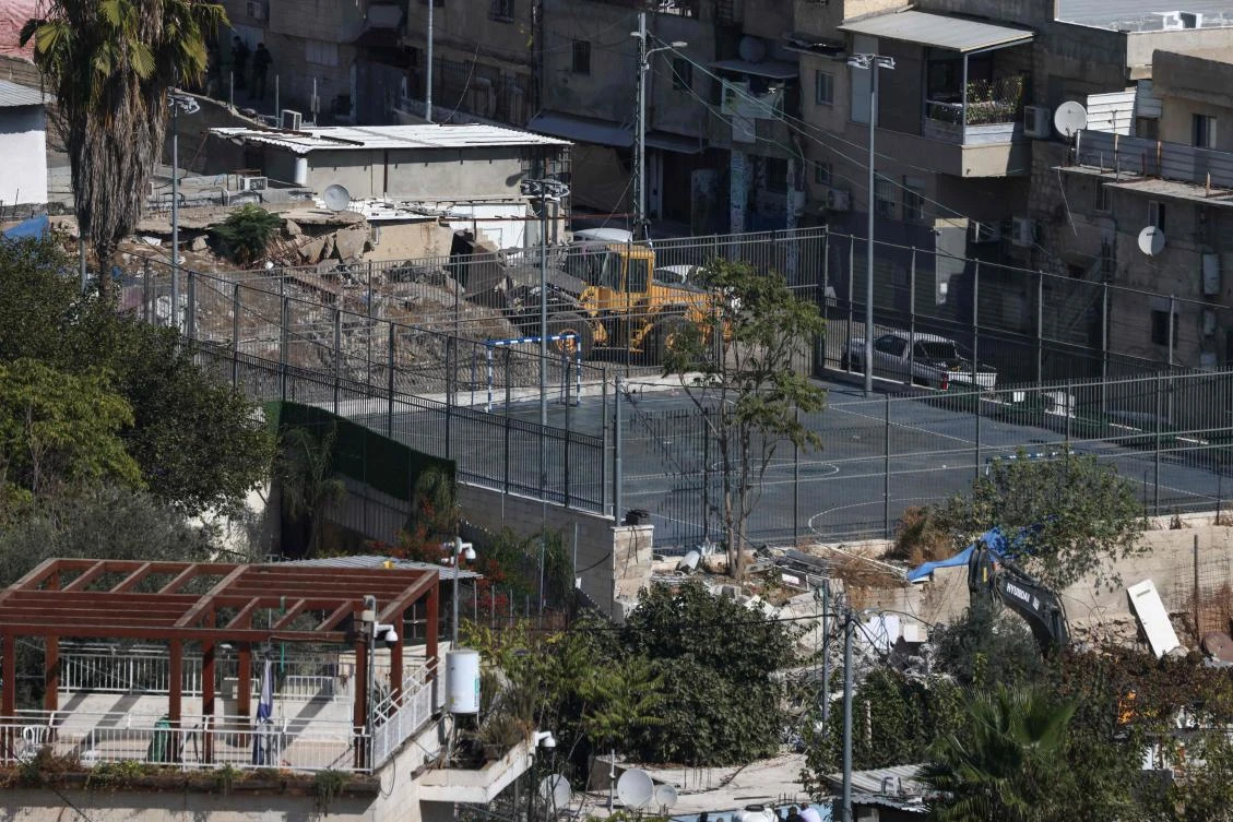 An excavator of the Israeli forces demolishes a house belonging to the Palestinian Ruwaidi family in the Al-Bustan neighborhood of the Arab town of Silwan in Israeli-annexed east Jerusalem on Nov. 5, 2024. (AFP)