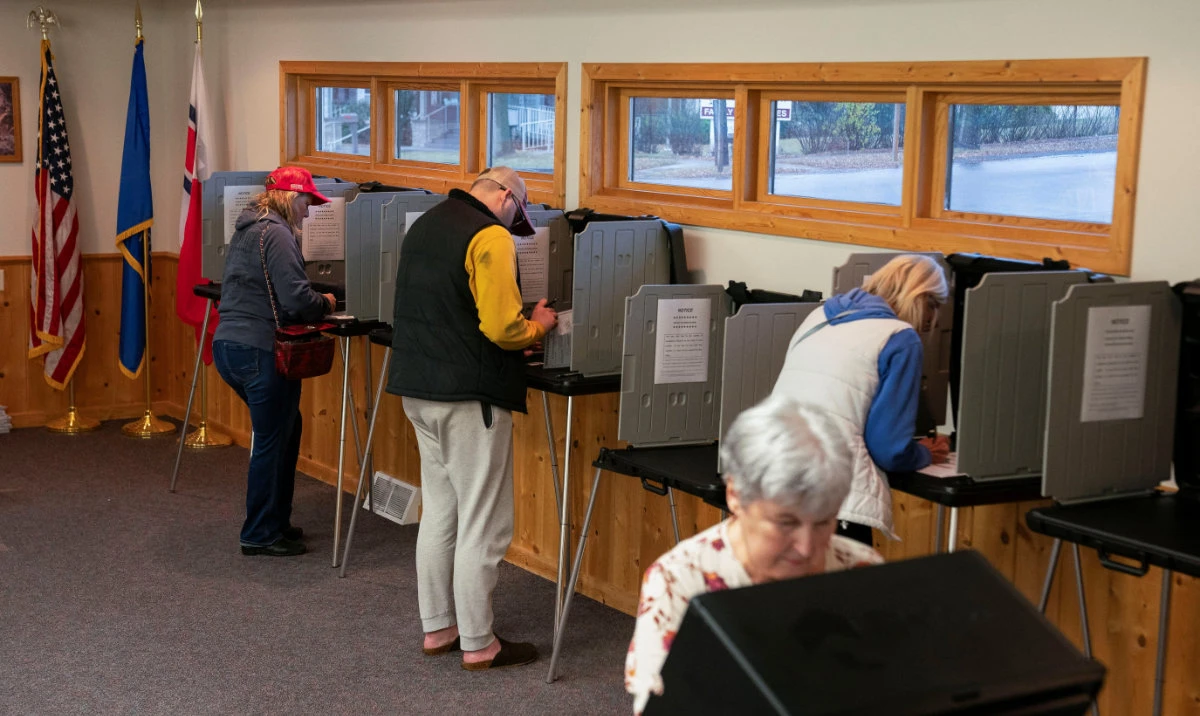 People vote in the US presidential election on Election Day at Sawyer County's Hayward City Hall polling location in Hayward, Wisconsin, US, November 5, 2024. (Reuters)