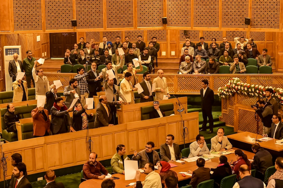 Jammu and Kashmir Chief Minister Omar Abdullah, center, looks on as members of the region’s legislative assembly shout slogans in support of a resolution to restore its special status during a session in Srinagar on Nov. 6, 2024. (AFP)