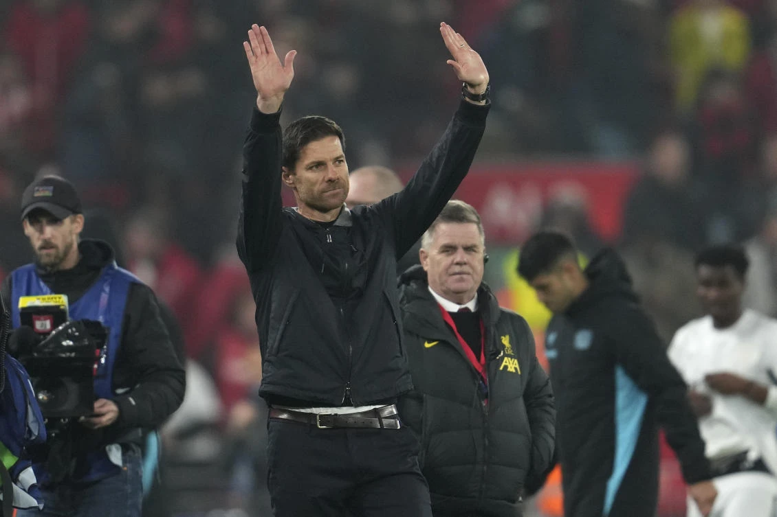 Leverkusen’s head coach Xabi Alonso waves to the crowd at the end of their Champions League opening phase match against Liverpool at Anfield in Liverpool, on Nov. 5, 2024. (AP)