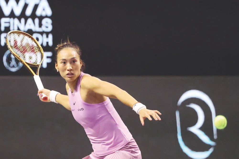 China’s Zheng Qinwen hits a return against Czech Republic’s Barbora Krejcikova during their women’s singles semifinal at the WTA Finals Championship in Riyadh on Friday. (AFP)