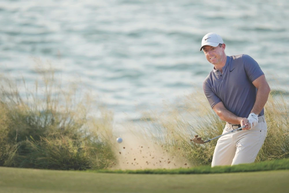 Rory McIlroy of Northern Ireland plays his second shot at the 17th hole during the second round of Abu Dhabi Golf Championship in Abu Dhabi, UAE, Friday. (AP)
