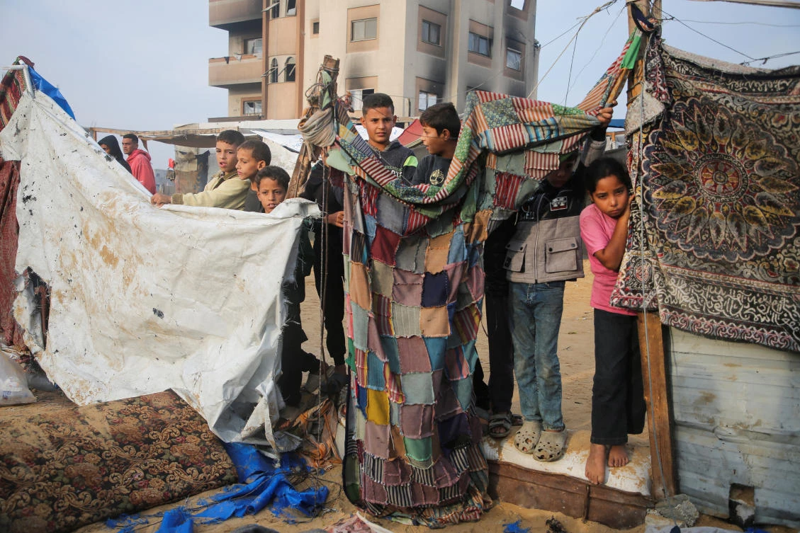 Palestinians stand at the site of an Israeli strike on a tent housing displaced people, in Khan Younis in the southern Gaza Strip November 9, 2024. (Reuters)