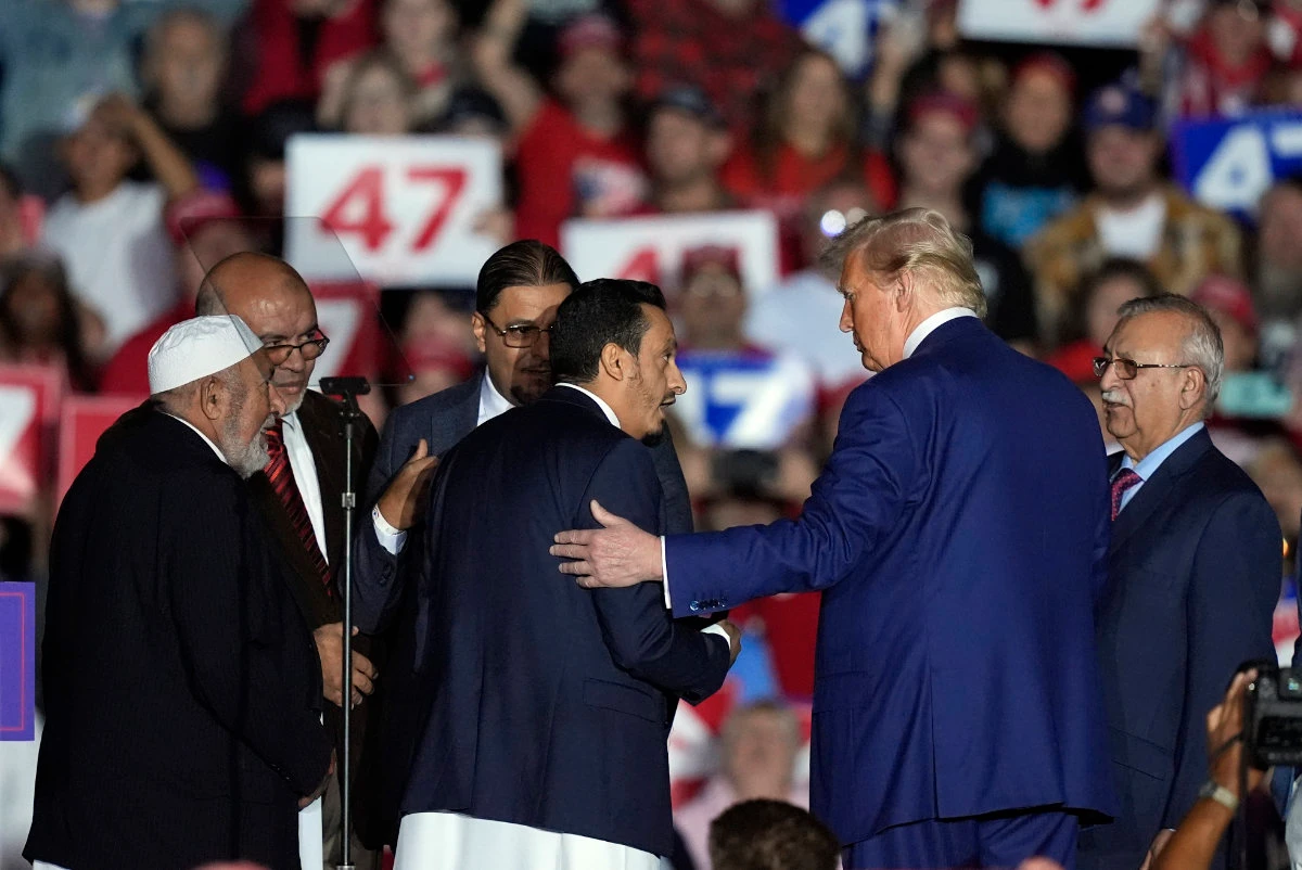 Republican presidential nominee former President Donald Trump, second right, greets local Muslim leaders during a campaign rally in Novi, Michigan on Oct. 26, 2024. (AP)