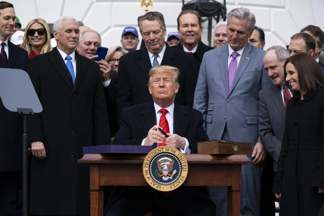 FILE - President Donald Trump signs a new North American trade agreement with Canada and Mexico, at the White House in Washington, Jan. 29, 2020. (AP)