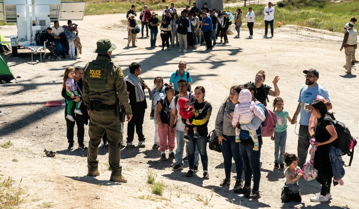 Asylum-seeking migrants line up near the border while waiting to be transported by the U.S. Border Patrol after crossing the border from Mexico into the U.S. in Jacumba Hot Springs, California, U.S. April 29, 2024. (REUTERS)