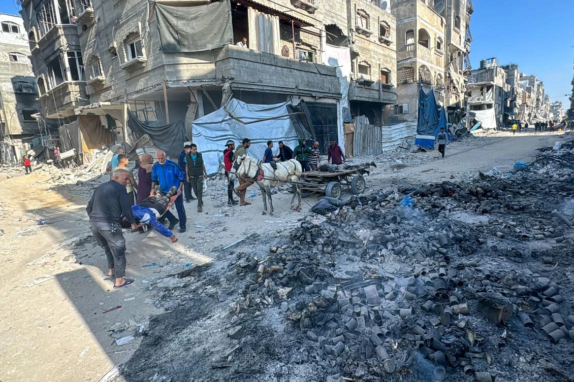 Palestinians carry bodies after an Israeli strike in Beit Lahia, northern Gaza Strip, on Nov. 13, 2024. (AFP)