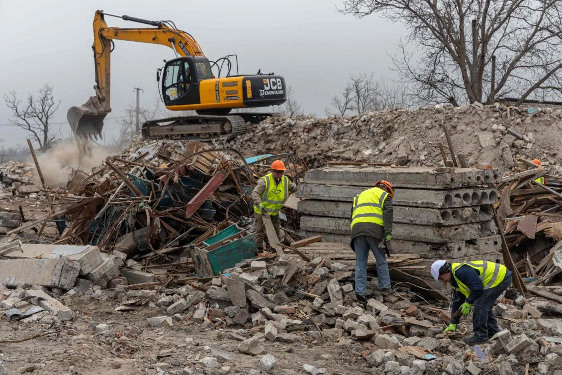 Above, workers for French company Neo-Eco clear debris of a school in the village of Lyubomyrivka, Mykolaiv region on Feb. 14, 2024. The company abandoned a project in Ukraine due to corruption. (AFP)