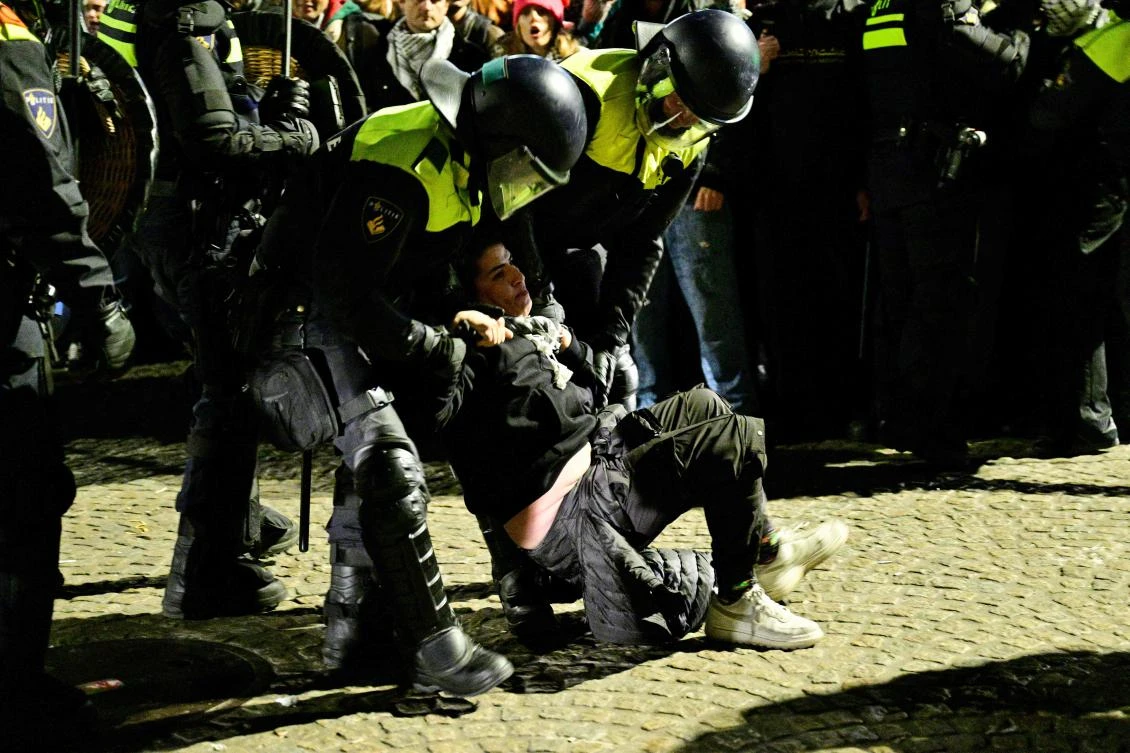 Police officers detain a protester during an unauthorized pro-Palestinian demonstration on Dam Square in Amsterdam on November 13, 2024. (AFP)