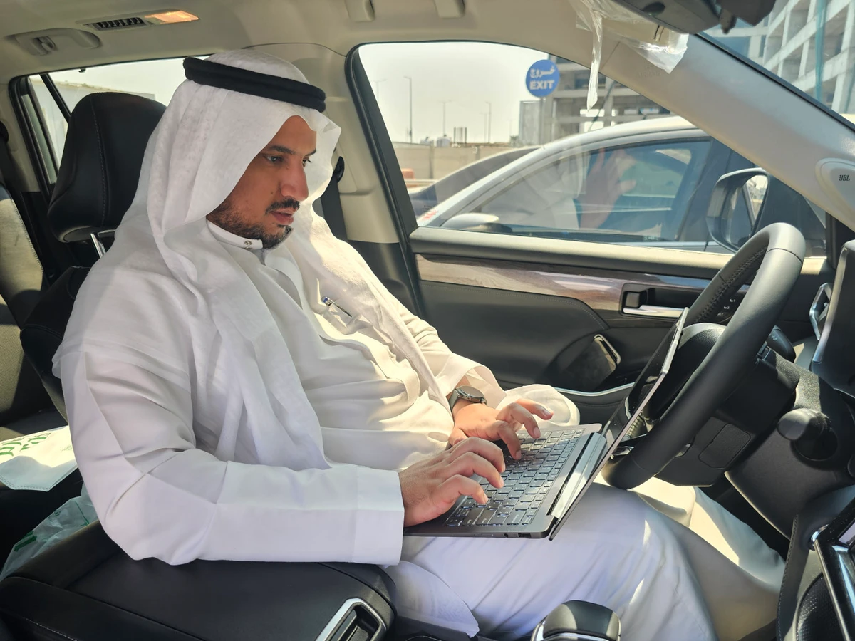 Saudi programmer and and automotive expert Nasser Mansour Al-Khaldi at work in his car. (Supplied)