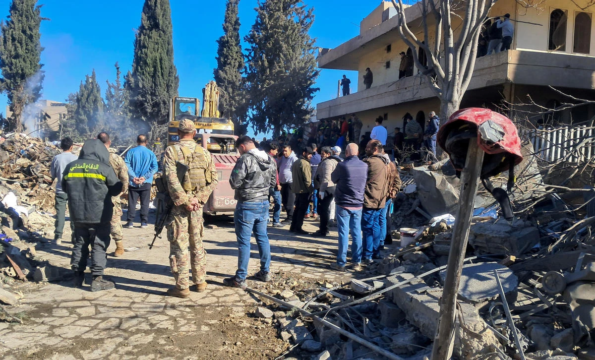 People gather at a damaged site, in the aftermath of an Israeli strike that hit a civil defense center in Baalbek on Nov. 15, 2024. (Reuters)