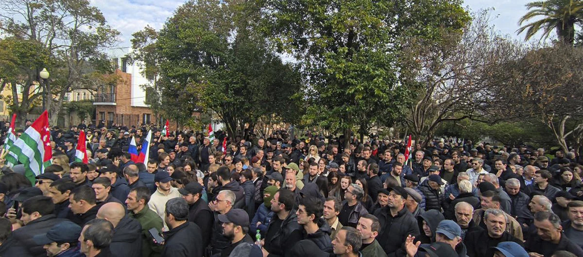 In this photo taken from video released by AIASHARA Independent Agency, Protesters gather outside the parliament building of the Georgian separatist region of Abkhazia as tensions flared over a proposed pact that would allow Russians to buy apartments in the region, Georgia, on Nov. 15, 2024. (AP)