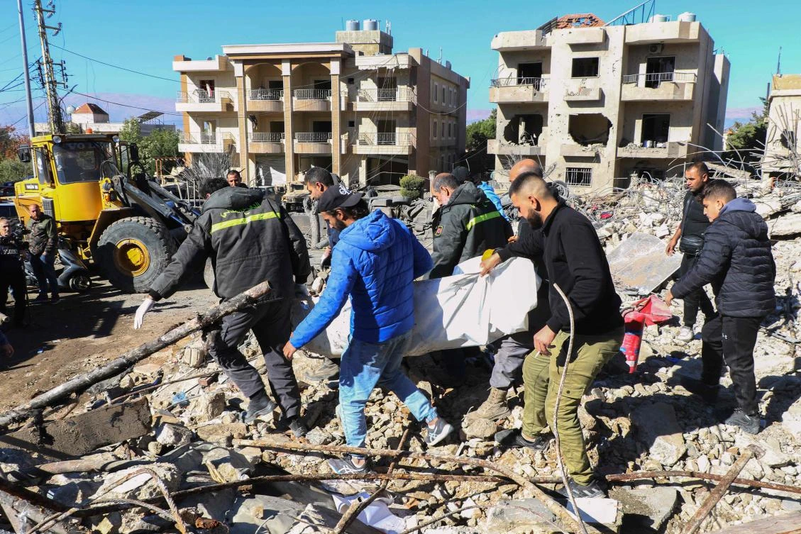 Rescuers evacuate the body of a civil defense officer from the site of an overnight Israeli airstrike that targeted a civil defense facility in Lebanon’s eastern village of Douris in the Bekaa valley, on Nov. 15. (AFP)