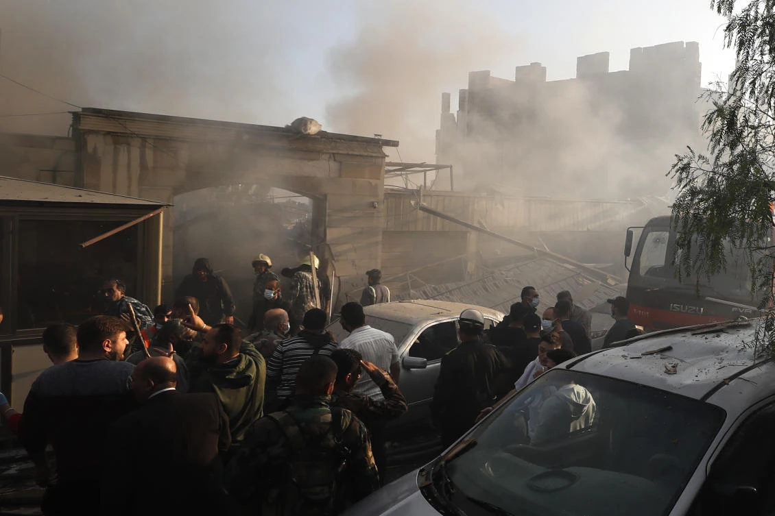 Security officers and rescuers gather at a destroyed building hit in an Israeli airstrike in Damascus on Nov. 14, 2024. (AP)