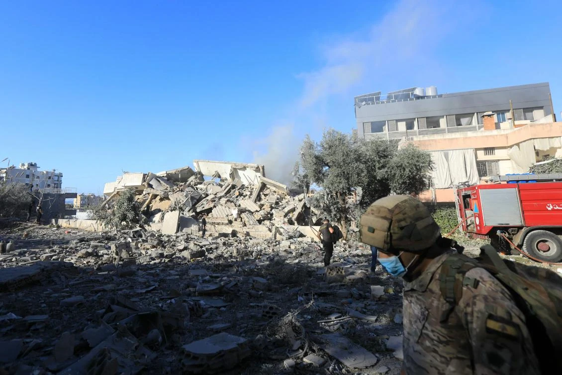 A Lebanese army soldier walks in front of a destroyed building following an Israeli airstrike that targeted the Hadath neighbourhood in Beirut’s southern suburbs on November 17, 2024. (AFP)