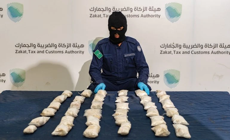 Zakat, Tax and Customs Authority's officer showing part of drugs shipment uncovered at Saudi ports (File/SPA)