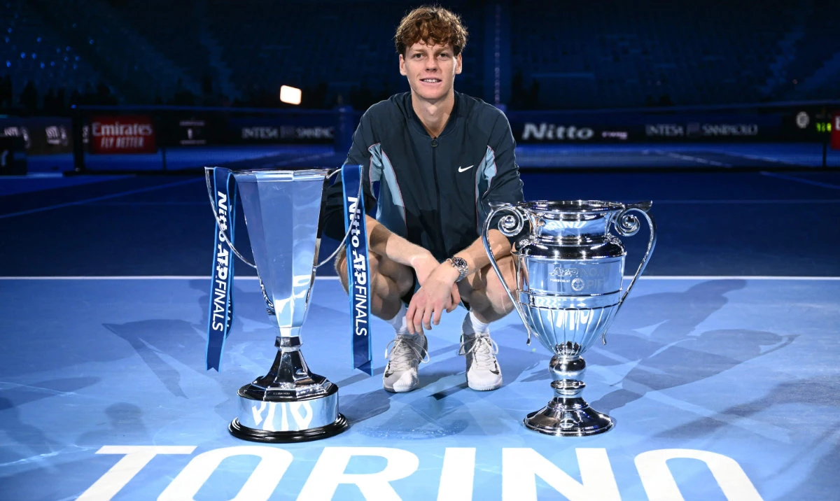 Italy's Jannik Sinner poses with the trophy of the tournament and the ATP year-end No.1 trophy, after winning the final against USA's Taylor Fritz at the ATP Finals tennis tournament in Turin on November 17, 2024. (AFP)