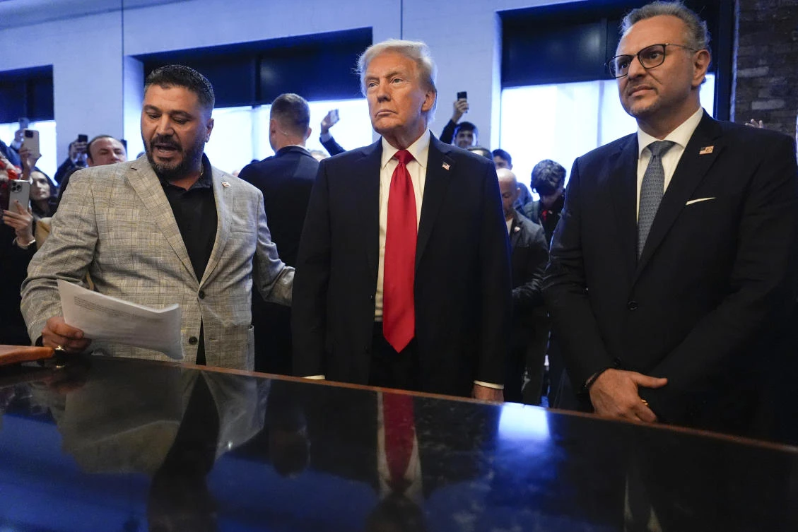 FILE - Republican presidential nominee former President Donald Trump, center, listens to Albert Abbas, owner of The Great Commoner, left, as Massad Boulos looks on during a visit to the cafe, Nov. 1, 2024, in Dearborn, Mich. (AP)