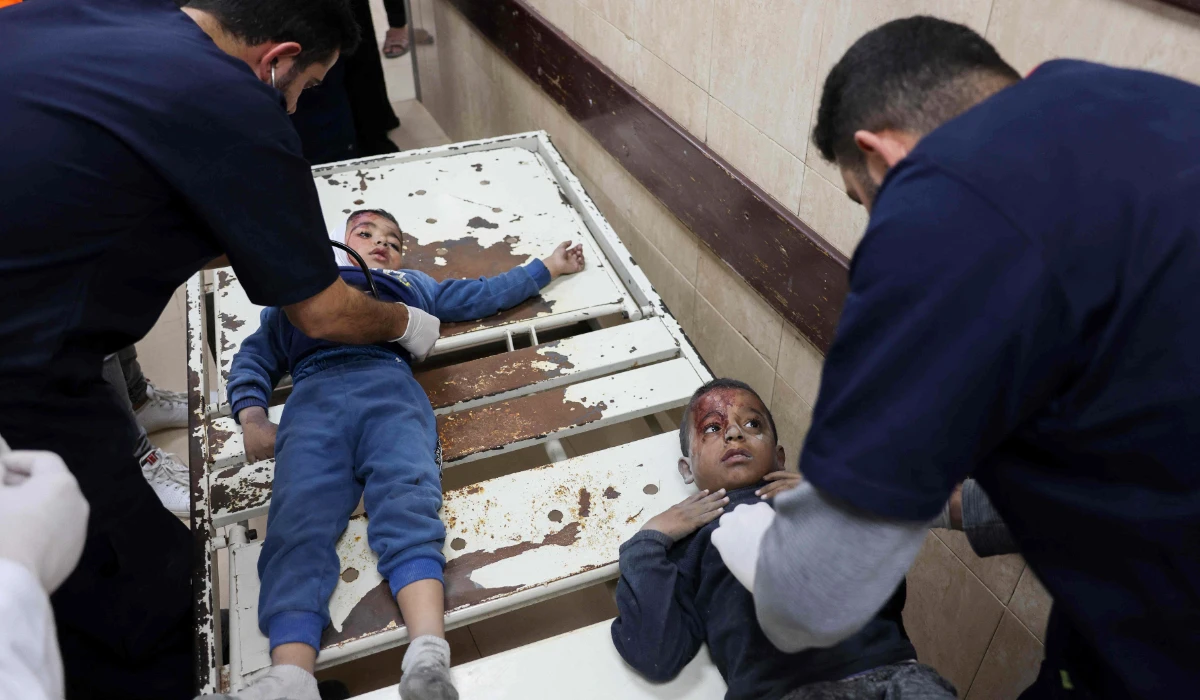 Medics tend to two wounded boys at al-Aqsa Martyrs Hospital in Deir Al-Balah in the central Gaza Strip on November 19, 2024, follwoing an Israeli strike in Bureij, amid the ongoing war between the Palestinian Hamas militant group and Israel. (AFP)