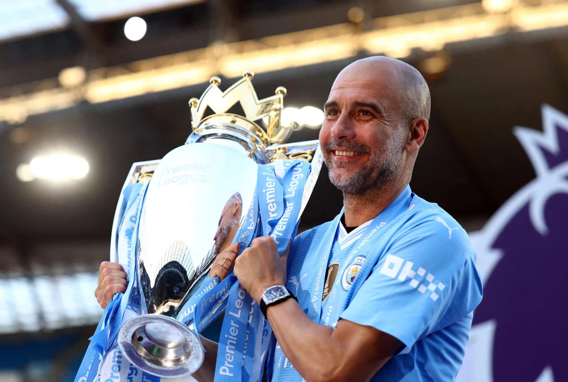 Manchester City manager Pep Guardiola celebrates with the trophy after winning the Premier League at Etihad Stadium, on May 19, 2024. (Reuters/File)