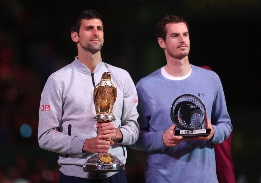 Serbia’s Novak Djokovic poses with the winner’s trophy after beating Britain’s Andy Murray during their final tennis match at the ATP Qatar Open in Doha on Jan. 7, 2017. (AFP)