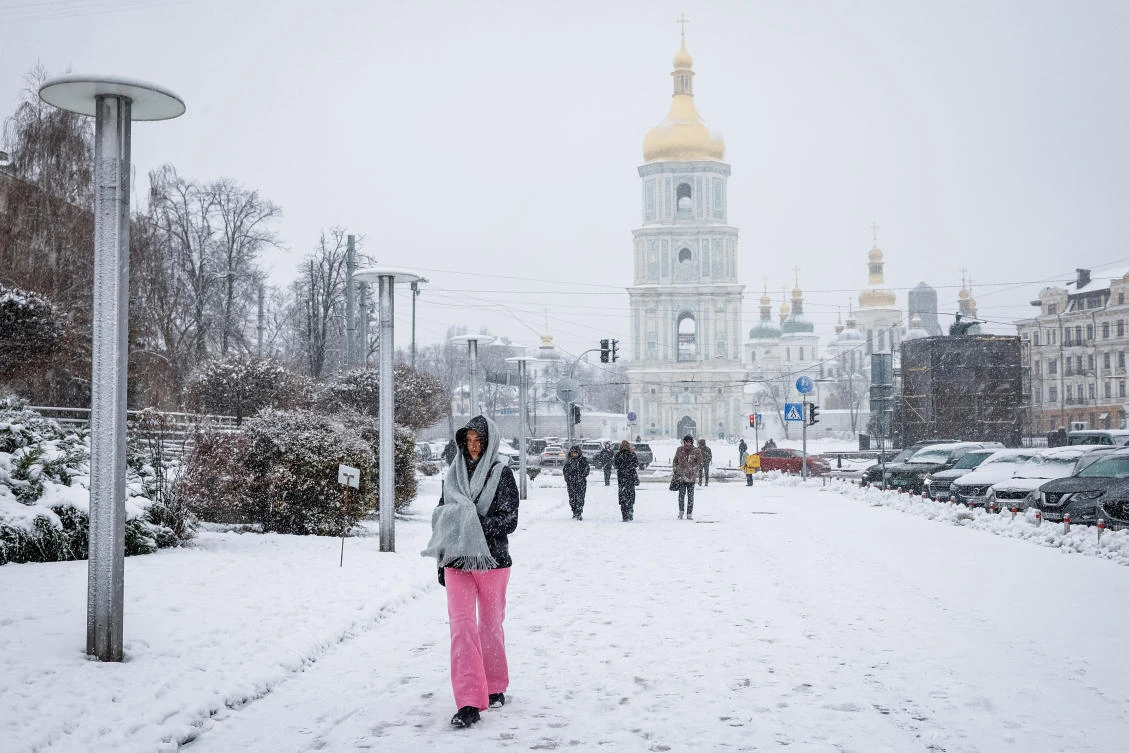 A woman walks on a snow-covered street during a snowfall, in Kyiv, Ukraine November 22, 2024. (Reuters)