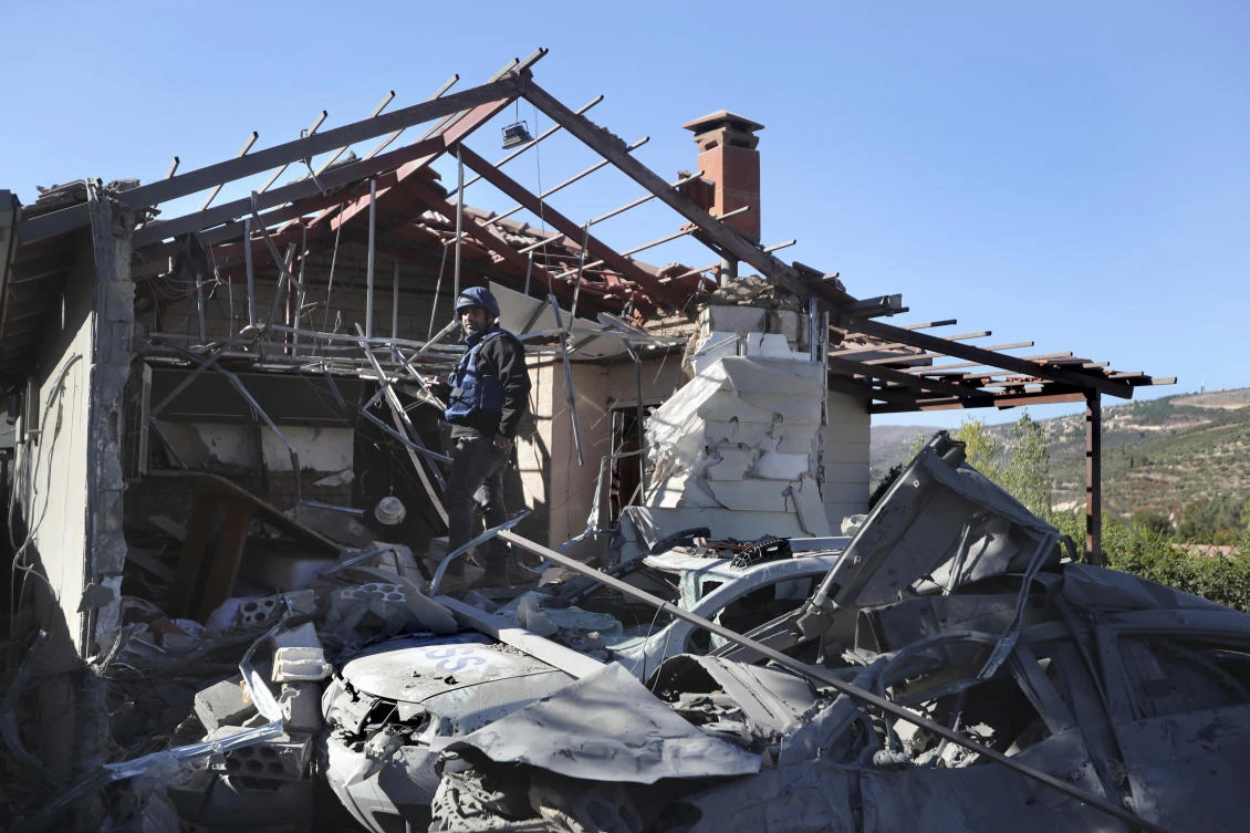 A journalist observes the site where an Israeli airstrike hit a compound housing journalists, killing three media staffers from two different news agencies according to Lebanon's state-run National News Agency, in Hasbaya village, southeast Lebanon, Friday, Oct. 25, 2024. (AP)