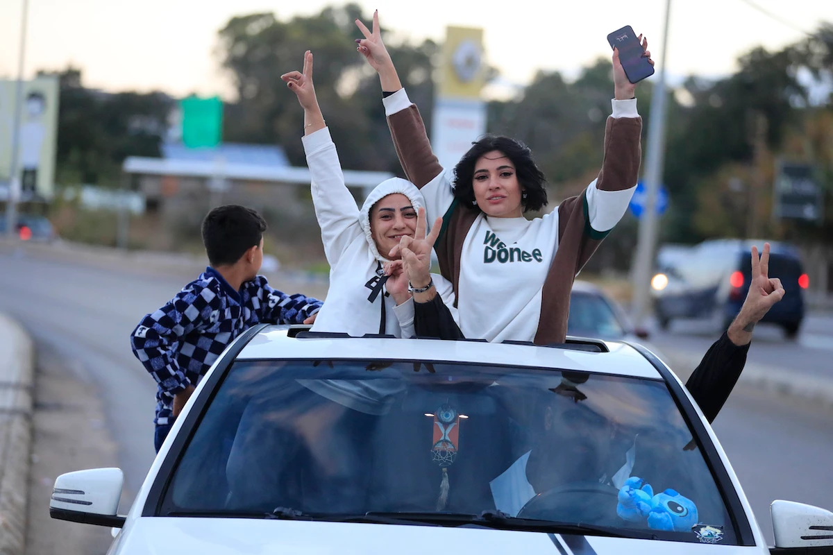 People celebrate after a ceasefire between Israel and Hezbollah went into effect in Sidon, Lebanon, Wednesday, Nov. 27, 2024. (AP)