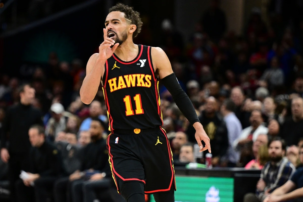 Atlanta Hawks guard Trae Young reacts after a three point basket in the second half of an NBA basketball game against the Cleveland Cavaliers Wednesday in Cleveland. (AP)
