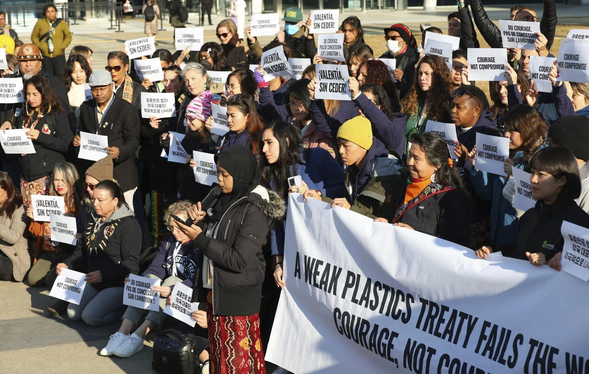 Environment activists call for a strong global plastics treaty outside of the venue for the fifth session of the Intergovernmental Negotiating Committee on Plastic Pollution in Busan, South Korea on Nov. 29, 2024. (Yonhap via AP)