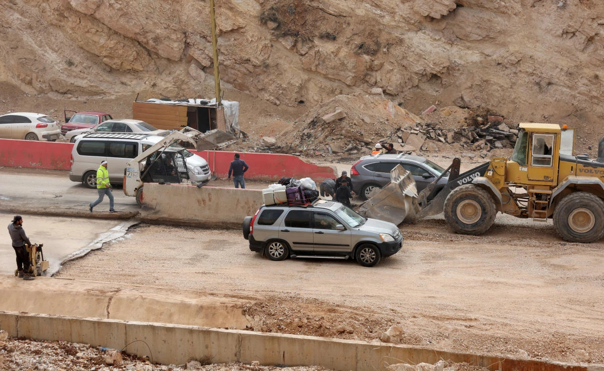 People who had fled the hostilities in Lebanon to Syria drive back with their belongings to Lebanon through the Masnaa border crossing between the two countries on Nov. 29, 2024. (Reuters)