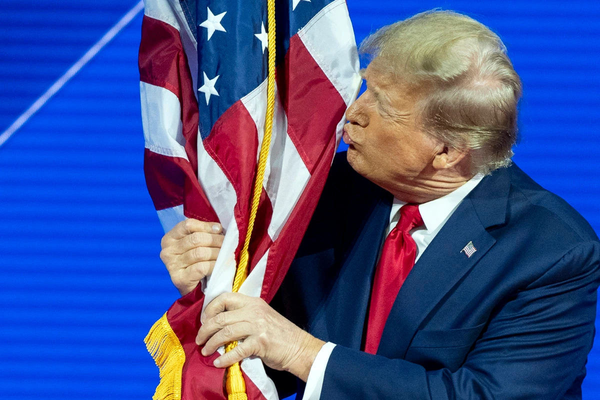 Donald Trump kisses the flag during the CPAC 2024 at National Harbor, in Oxon Hill, Maryland on Feb. 24, 2024. (AP/File)